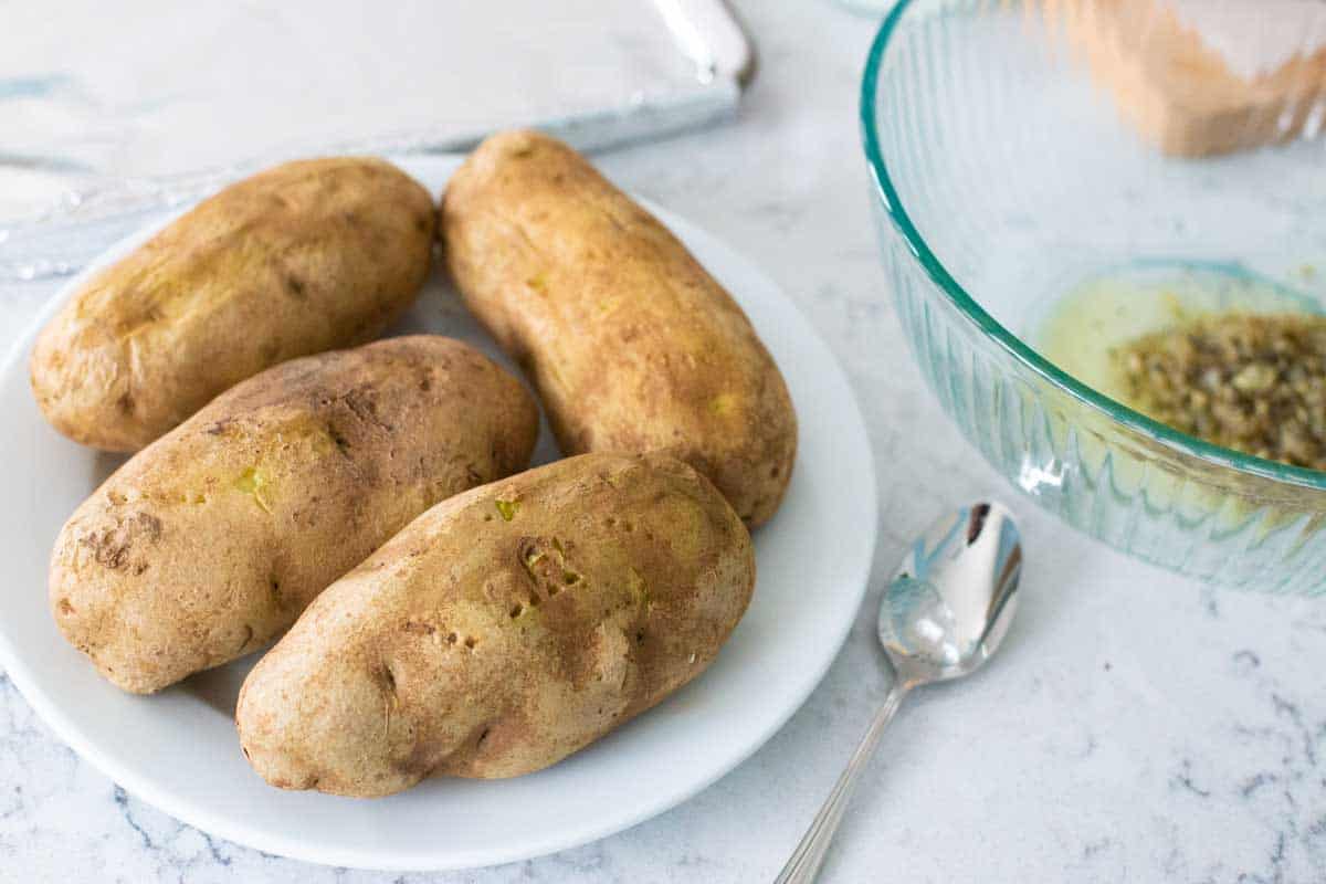 The potatoes have been pricked by a fork and microwaved until tender.