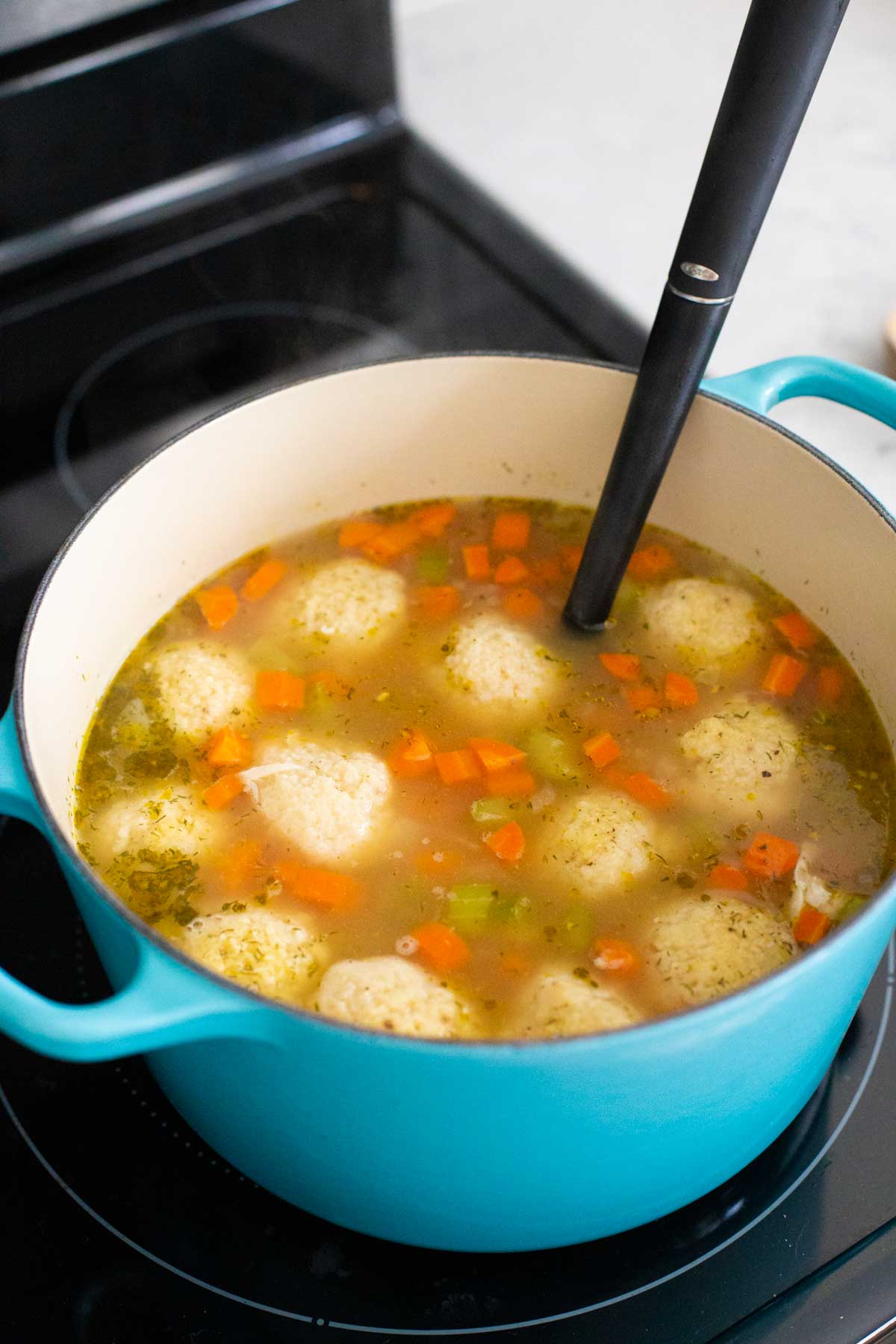 The finished matzoh ball soup has the chicken added last to just heat through.
