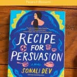 A copy of the book Recipe for Persuasion by Sonali Dev sits on a table.