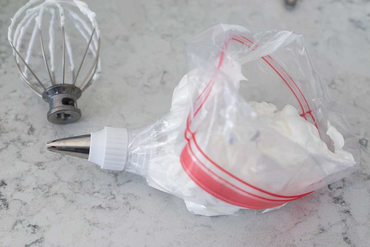 A plastic zip top bag has been turned into a piping bag for the meringue.