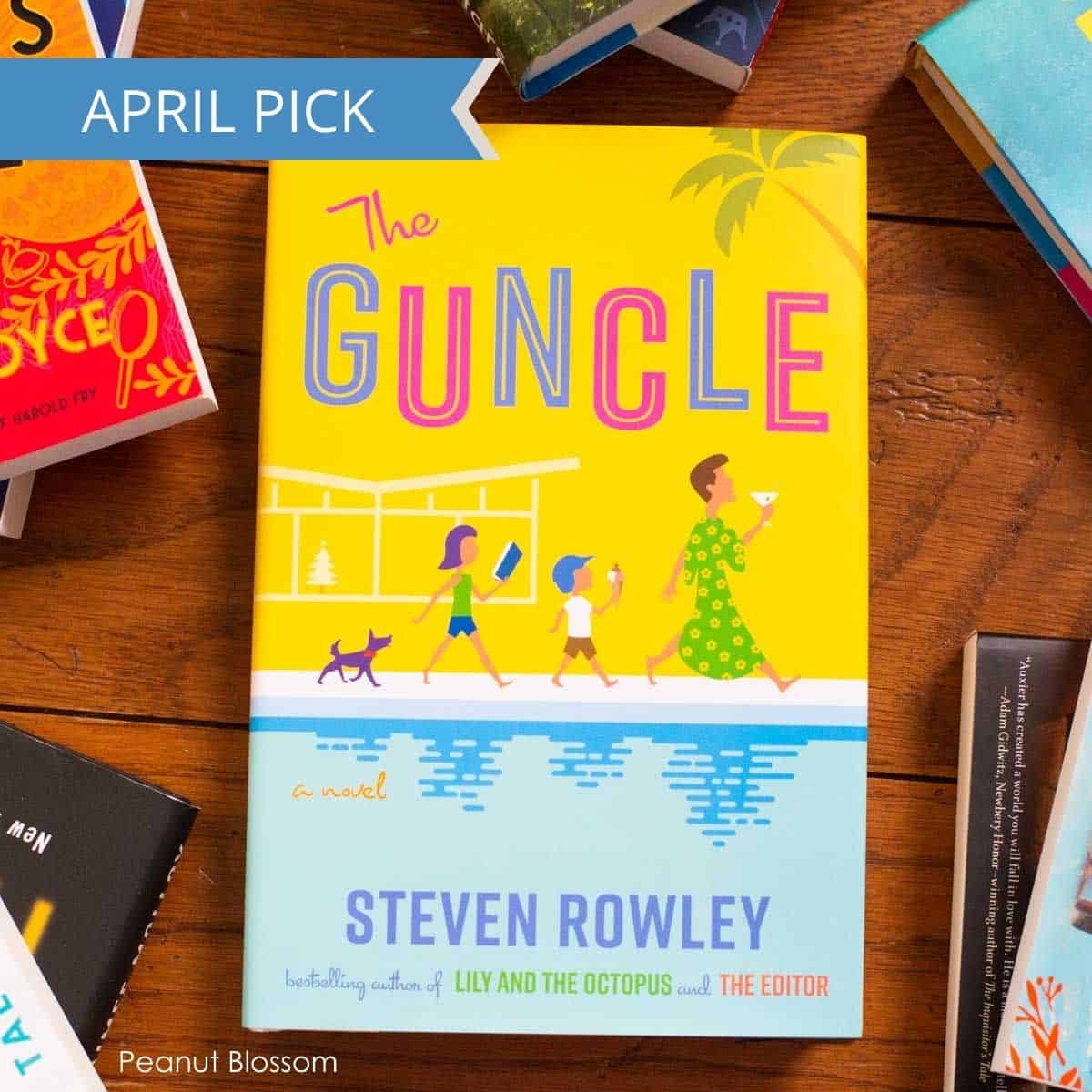 A copy of The Guncle by Steven Rowley sits on a table.