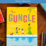 A copy of The Guncle by Steven Rowley sits on a table.