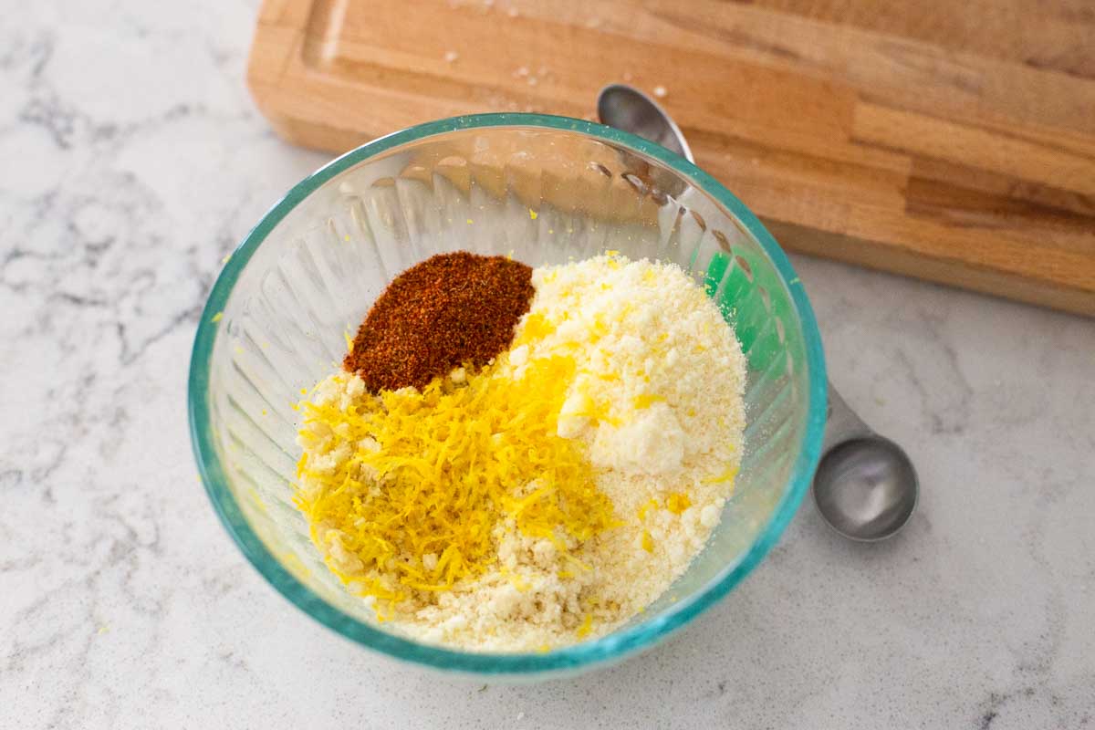 The bread crumbs, lemon zest, and seasonings are in a mixing bowl.