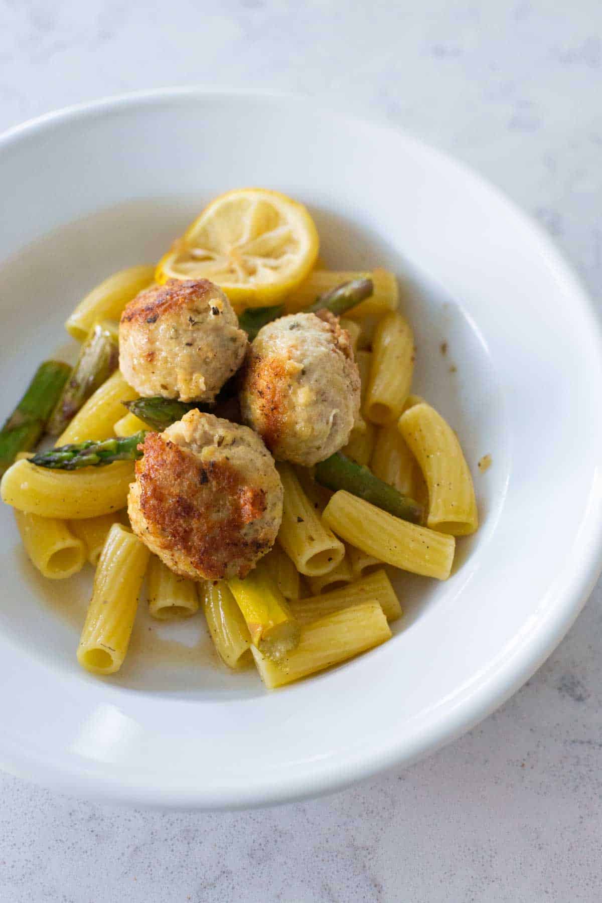 The chicken meatballs are served over rigatoni noodles. 