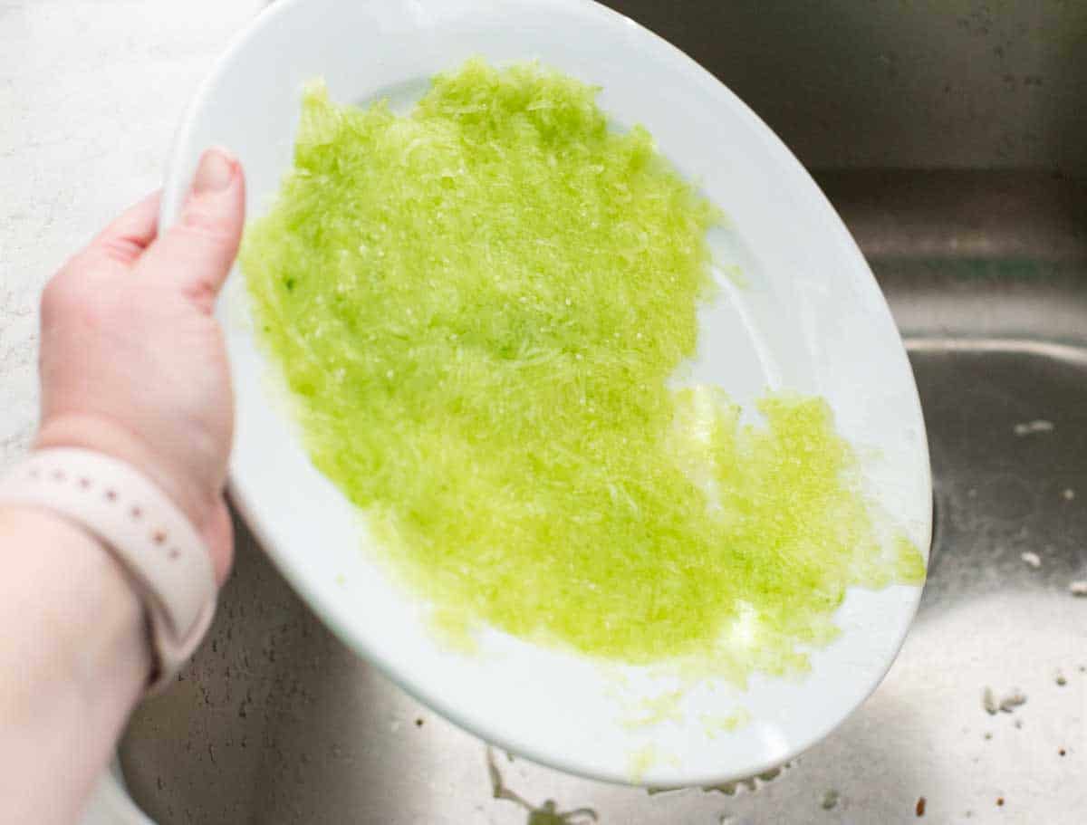 Fresh grated cucumber has been pressed against a plate to release the liquid.