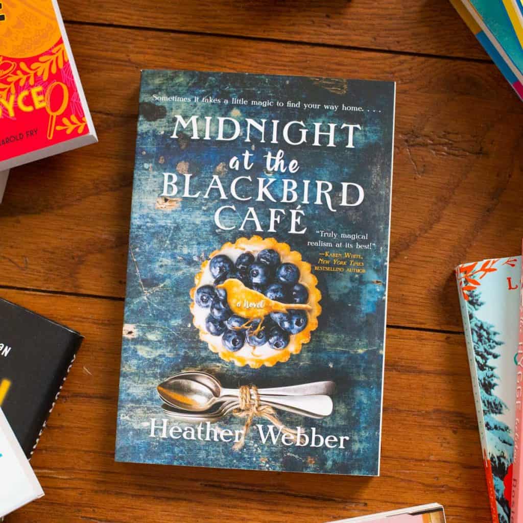 A copy of Midnight at the Blackbird cafe sits on a table.