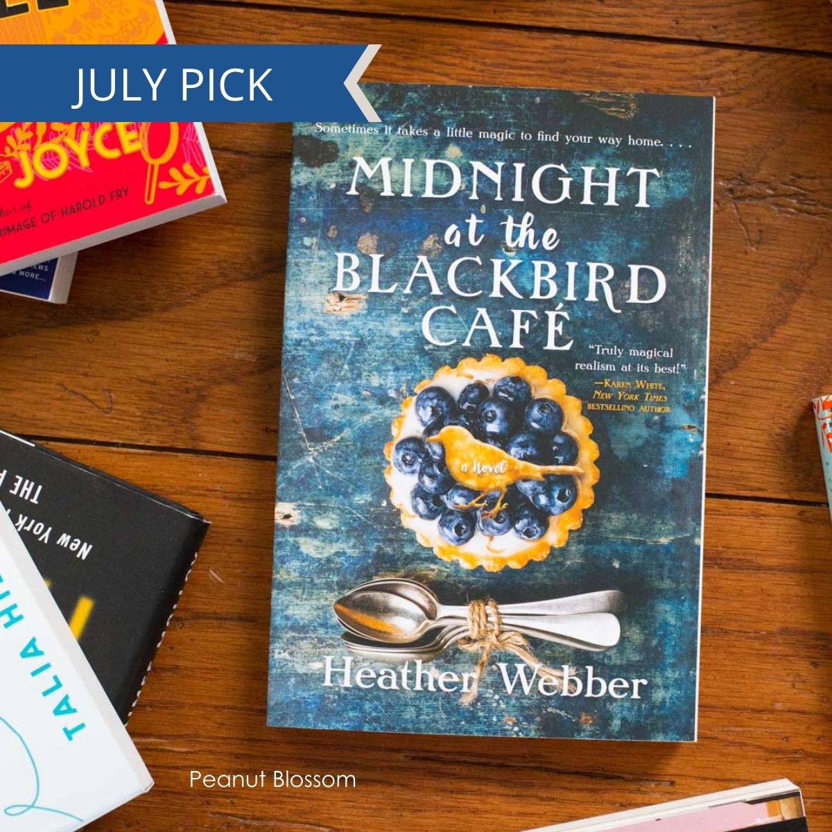 A copy of Midnight at the Blackbird cafe sits on a table.