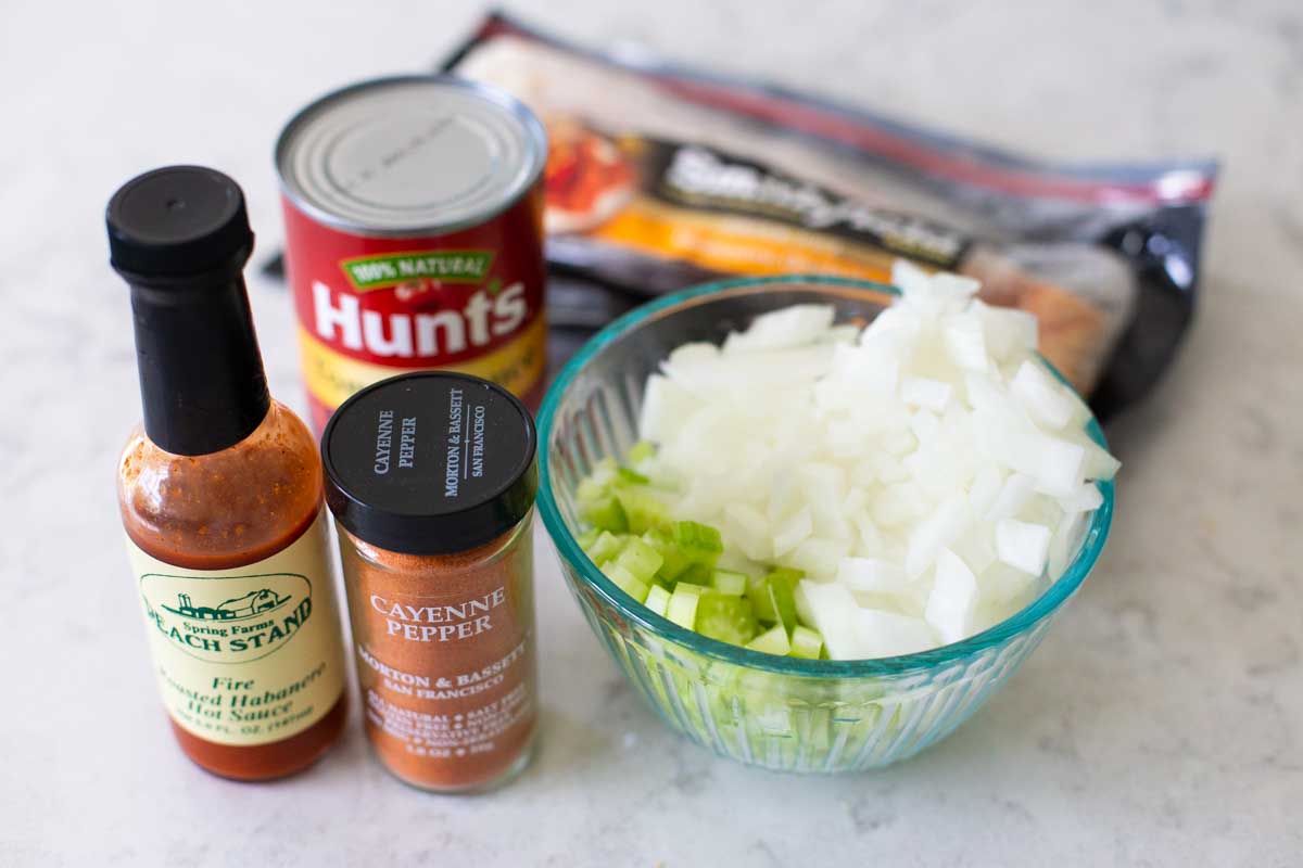 The ingredients to make baked red rice are on the counter.