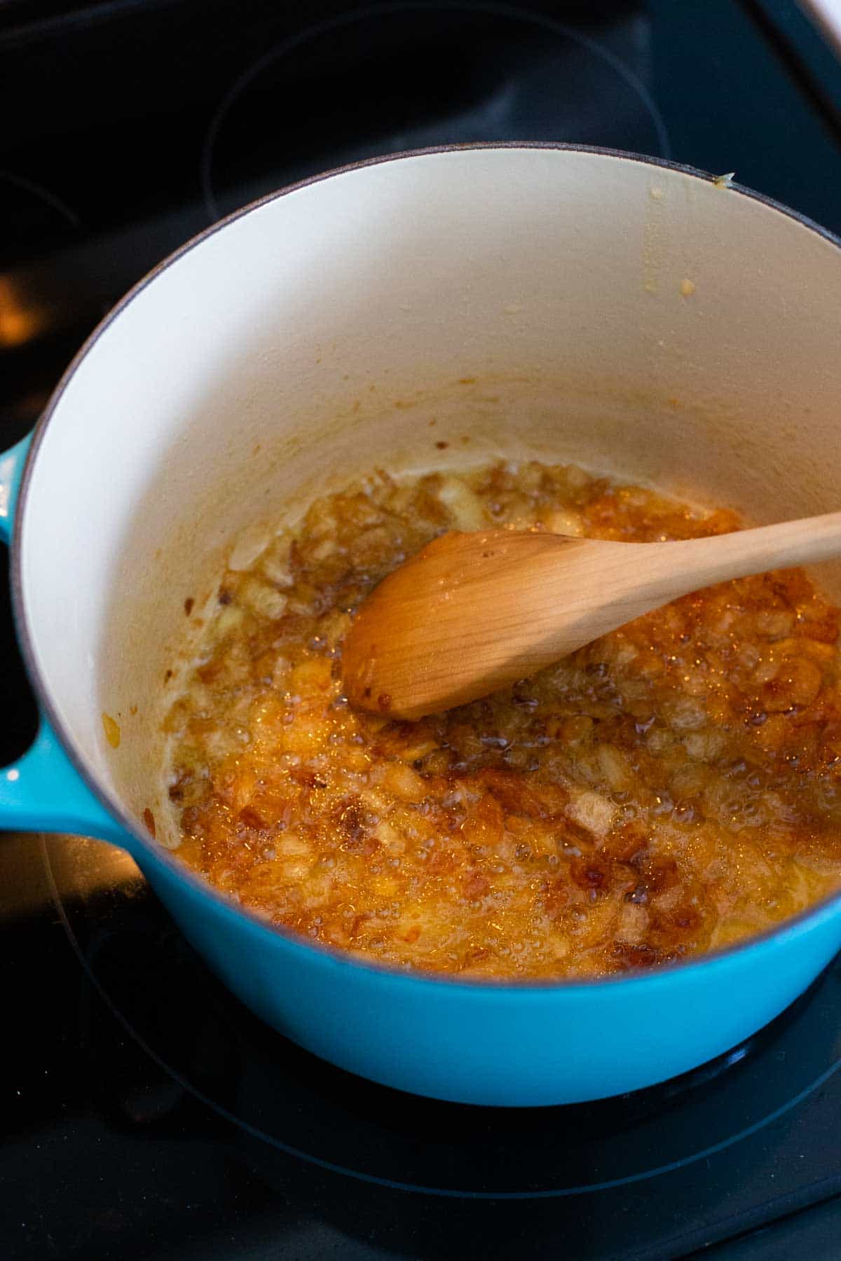 The onions are now a deep golden brown color after being caramelized in the pot.