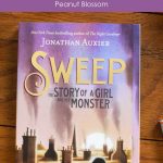 A copy of Sweep by Jonathan Auxier is on the table.
