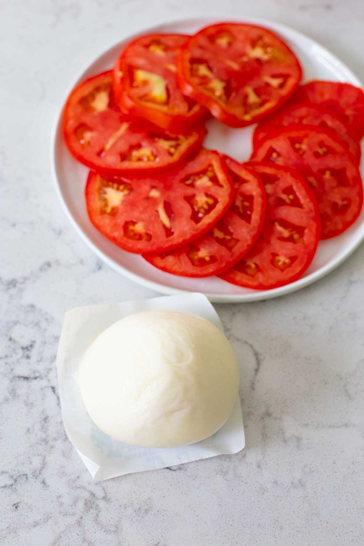 The tomatoes have been placed in a spiral circle on a white plate.