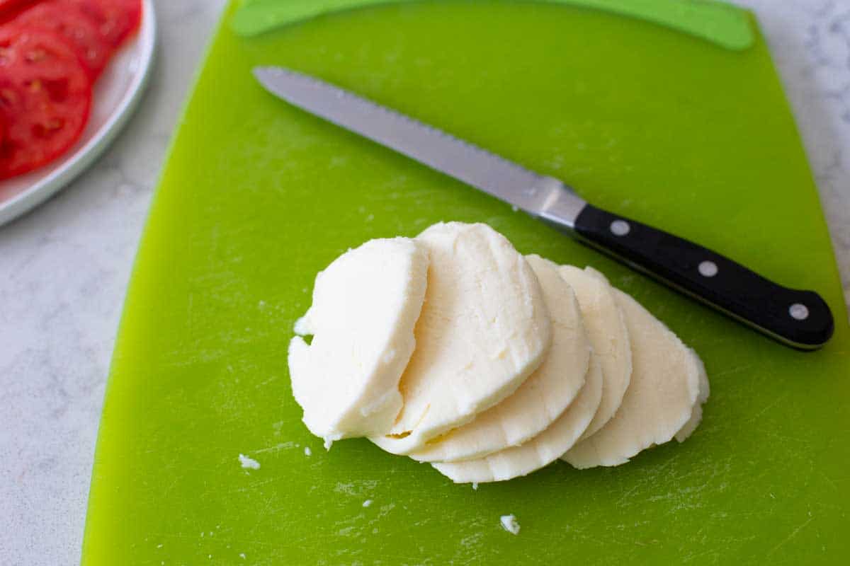 The mozzarella ball has been sliced with a serrated knife.