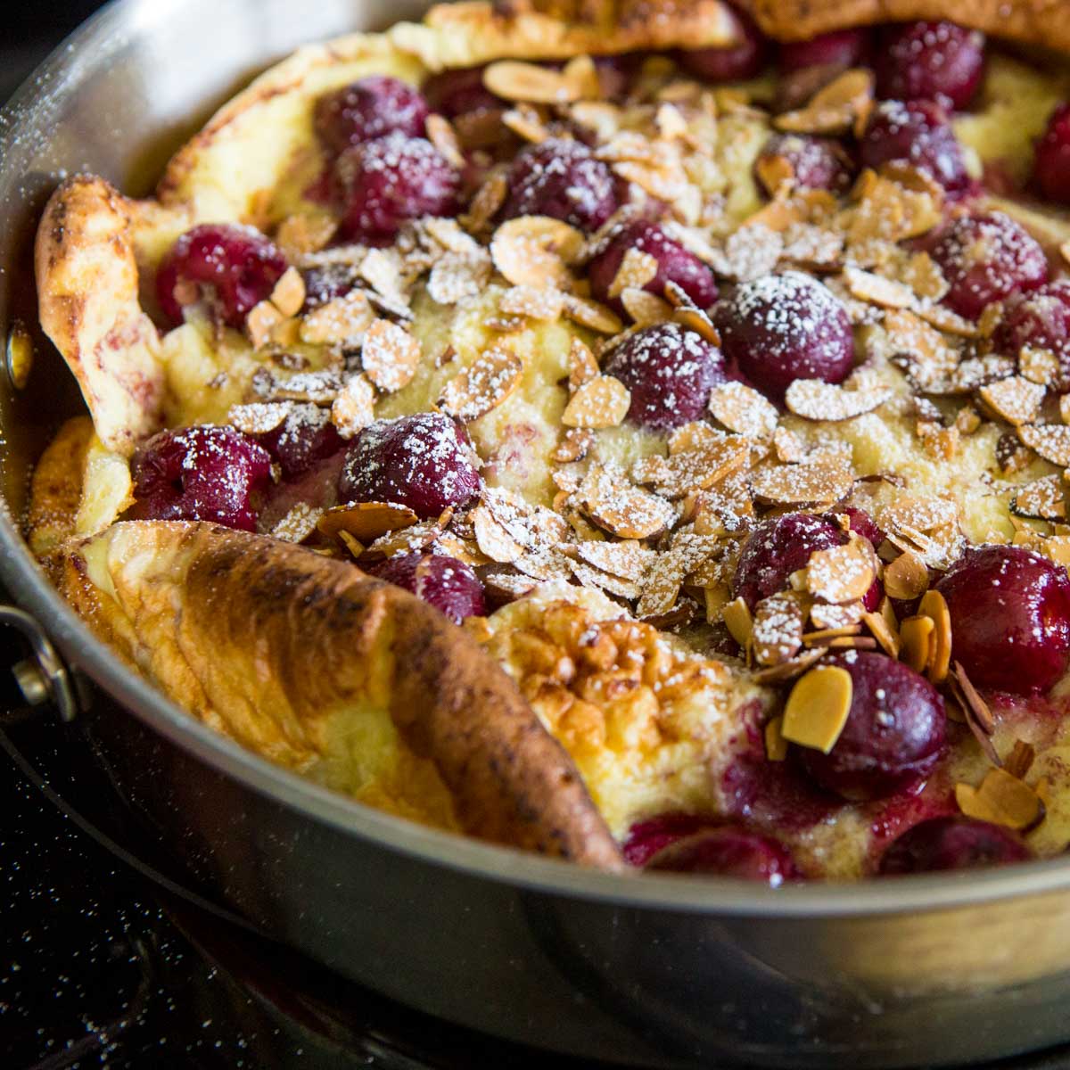 The baked cherry clafouti is in the skillet.