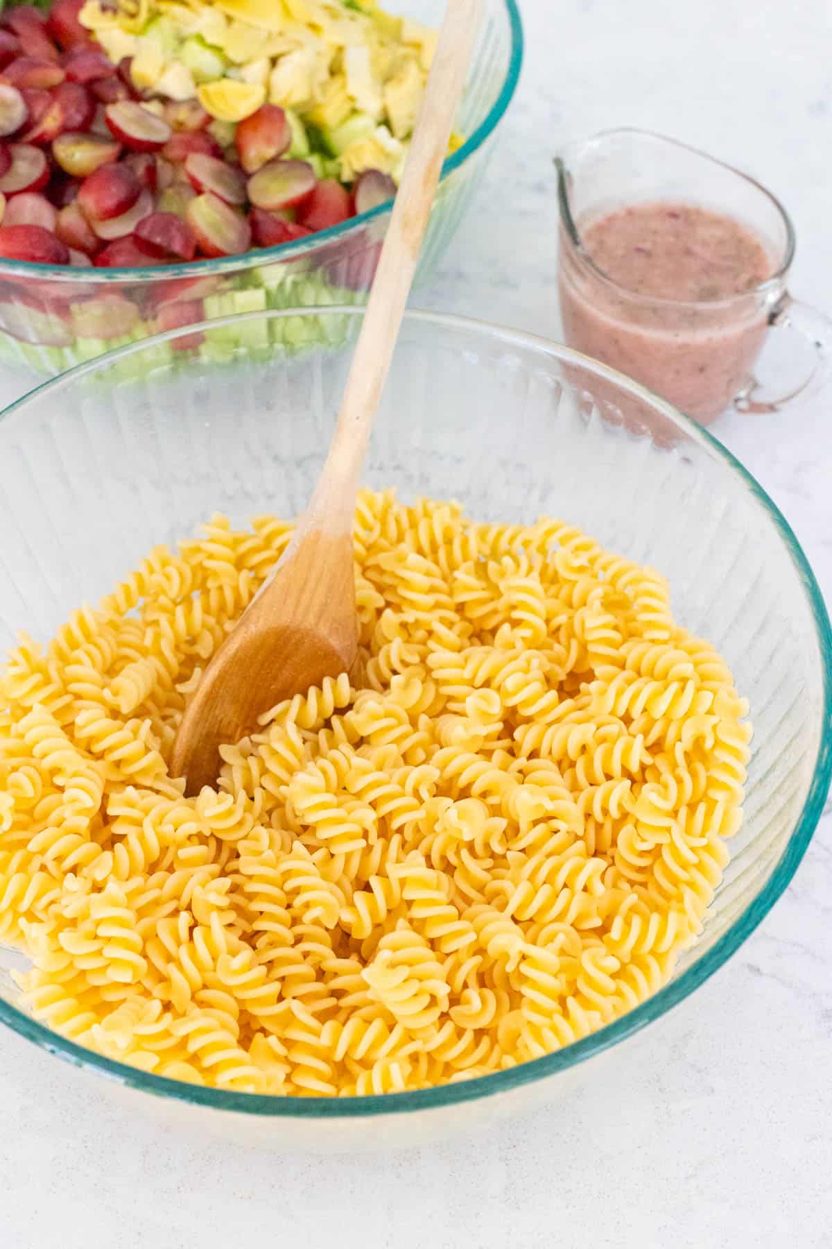 The cooked rotini noodles are in a large mixing bowl.
