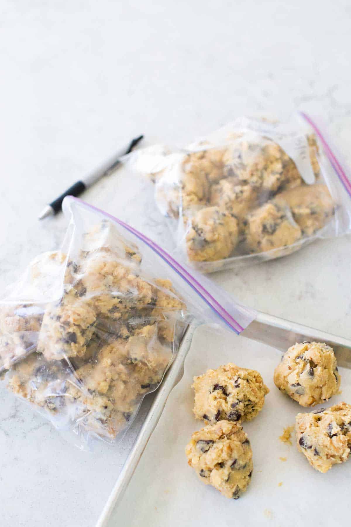 The cookie dough balls are flash frozen and being transferred to plastic bags.