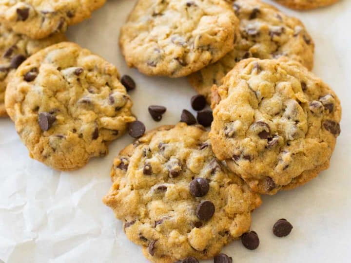 Baked chocolate chip walnut cookies with chocolate chips sprinkled over the top.