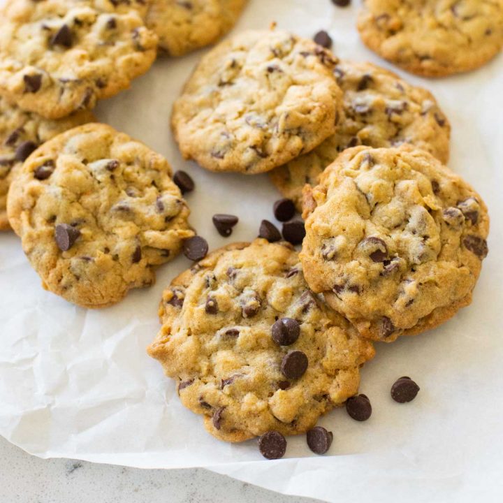 Baked chocolate chip walnut cookies with chocolate chips sprinkled over the top.