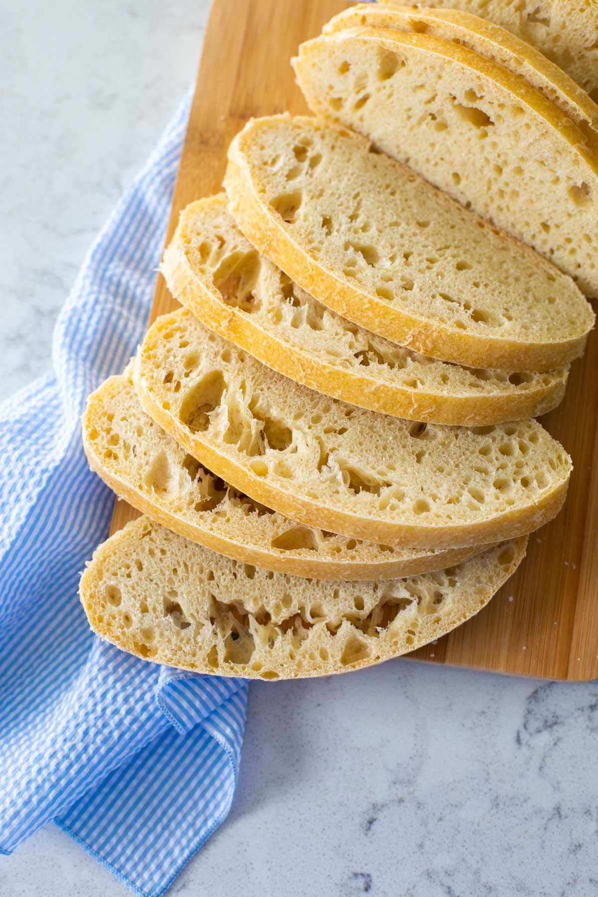 A sliced loaf of fresh ciabatta bread has been prepared in the bread machine and baked in the oven.