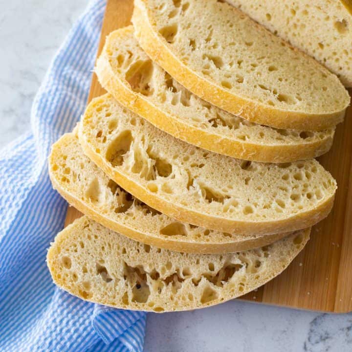 A sliced loaf of fresh ciabatta bread has been prepared in the bread machine and baked in the oven.