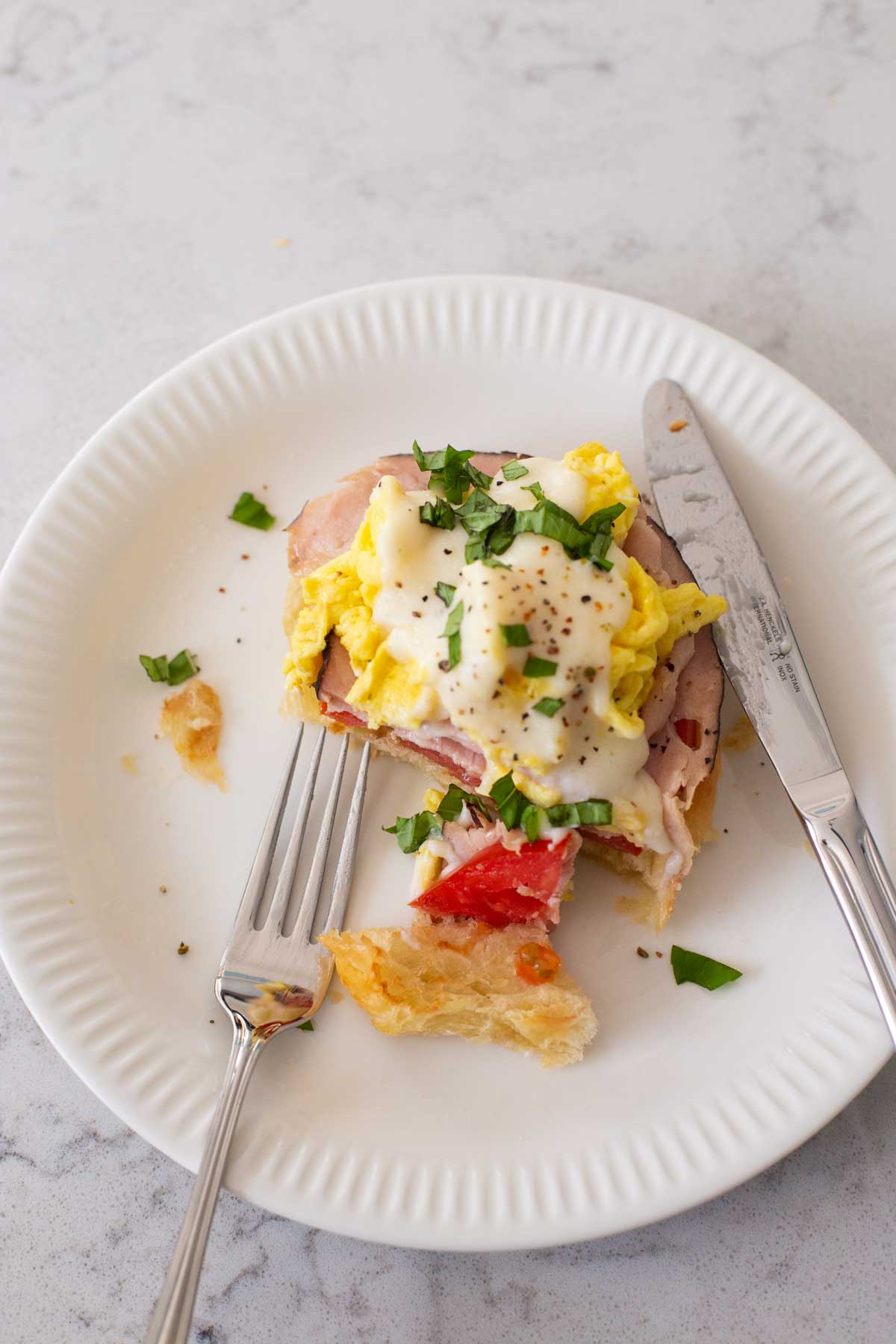 The easy eggs benedict variation has been cut with a fork and knife.