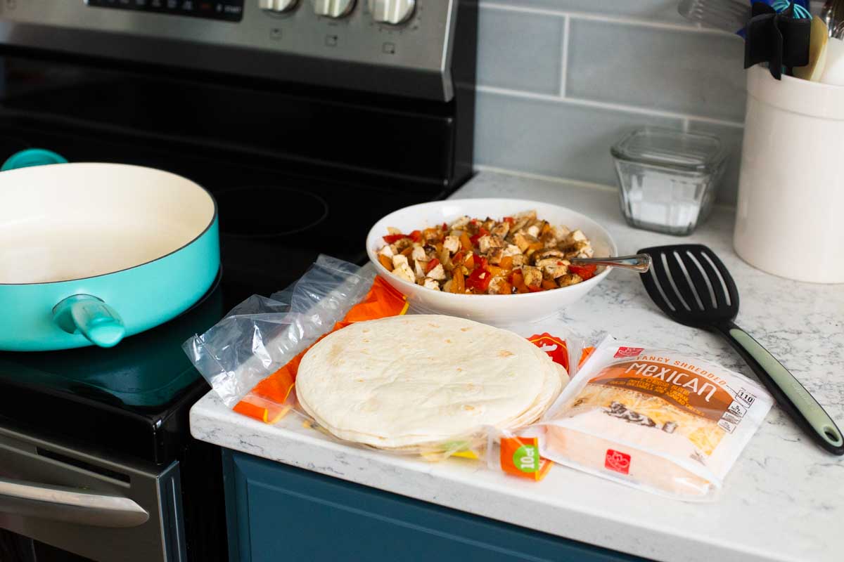 The assembly station to make a big batch of quesadillas are on the counter.