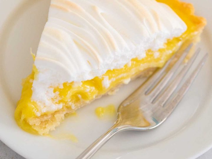 A piece of lemon pie with lemon curd filling.