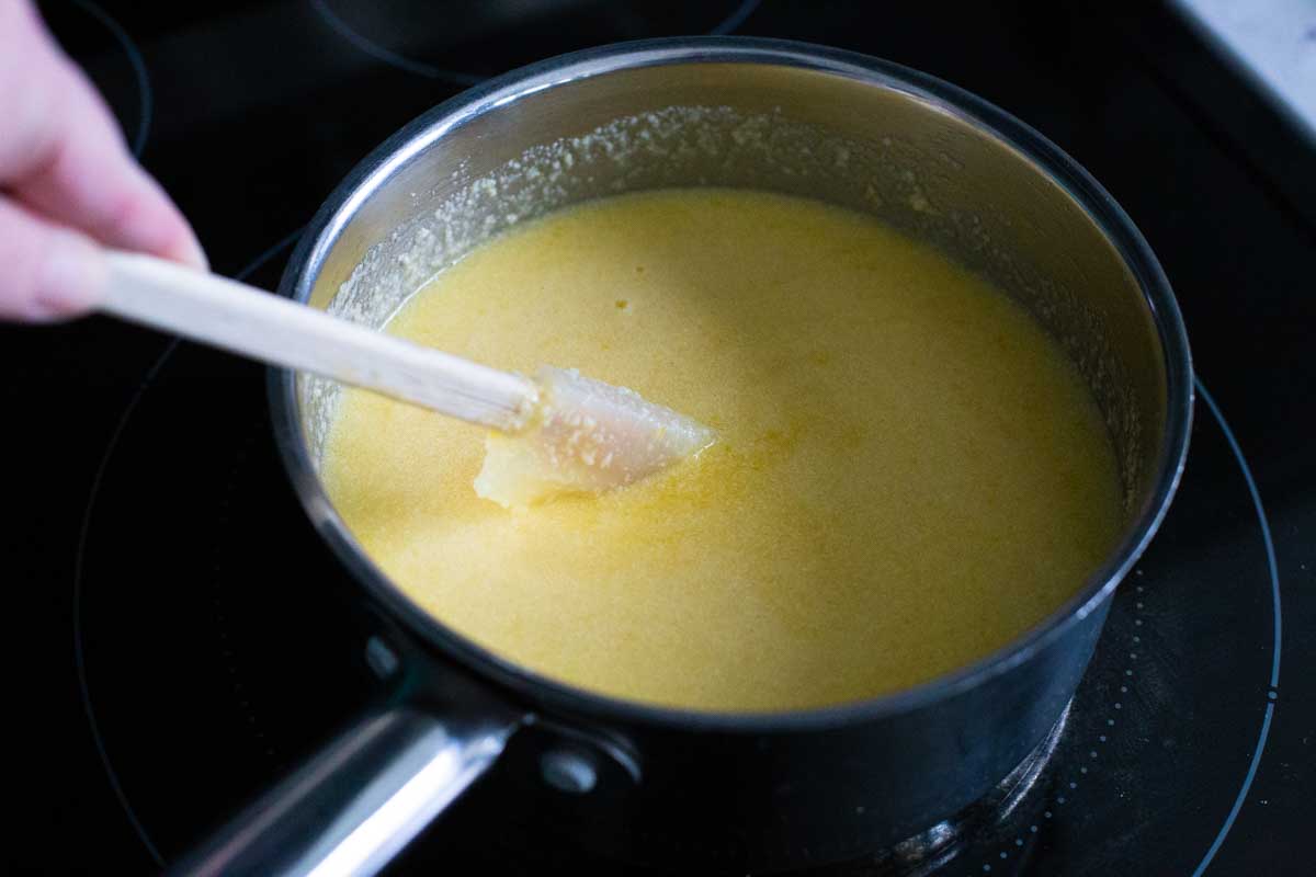 The lemon curd base has been placed in a saucepan for cooking.