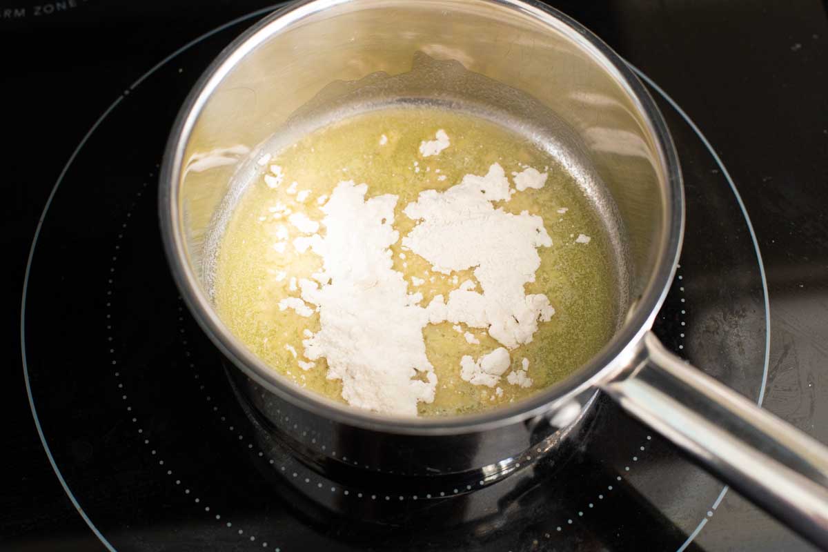 The flour has been added to the melted butter in a sauce pan.