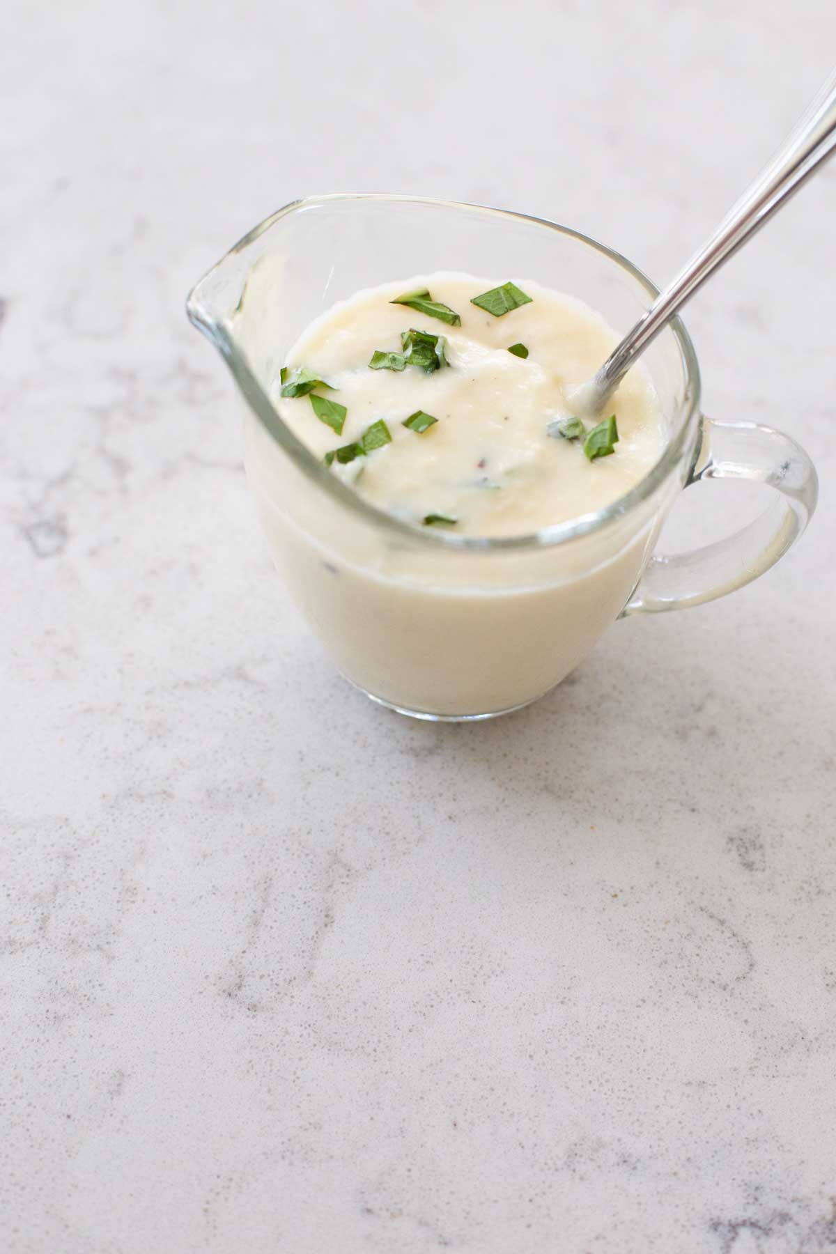 The fresh basil has been added to the cream sauce.