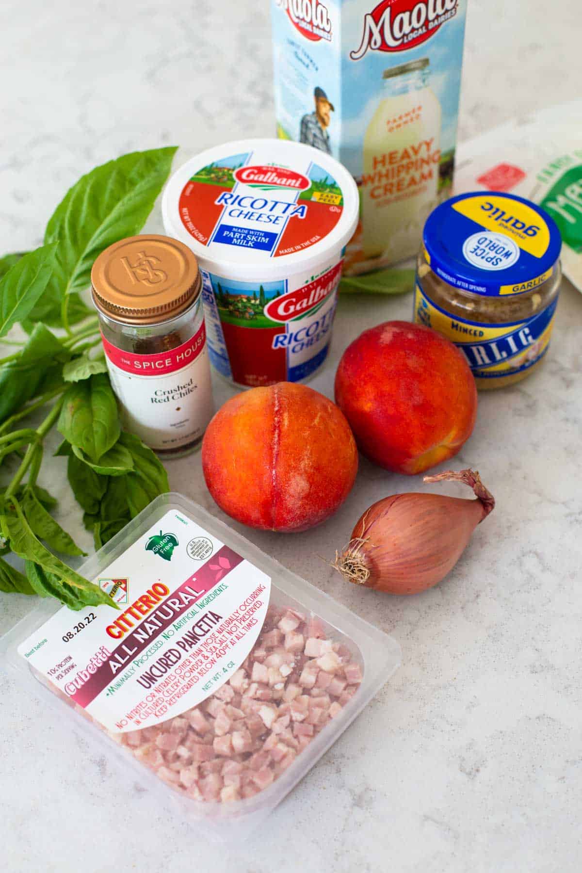 The ingredients to make peach pizza are on the counter.