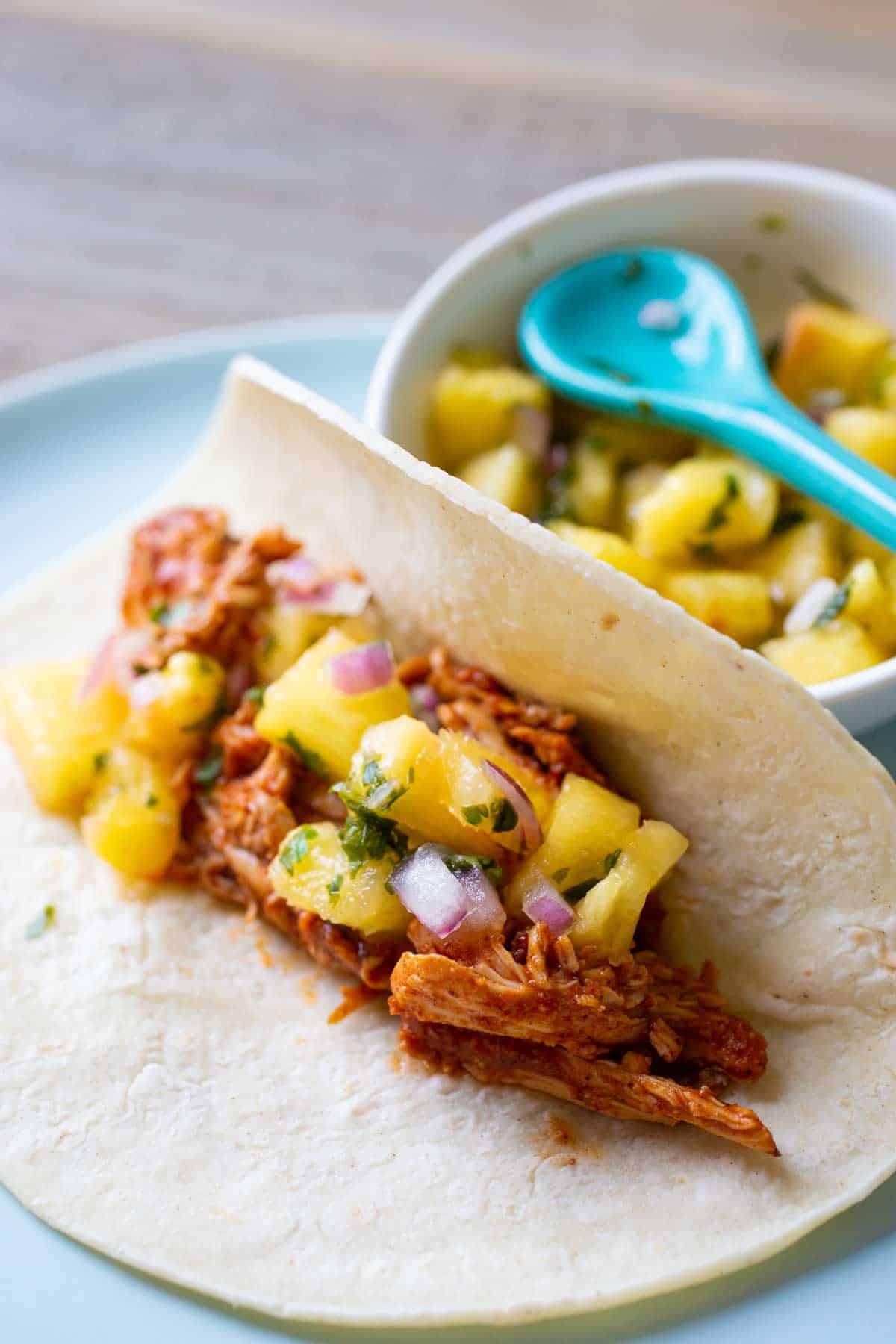 The pineapple salsa is served spooned over chicken tacos. 