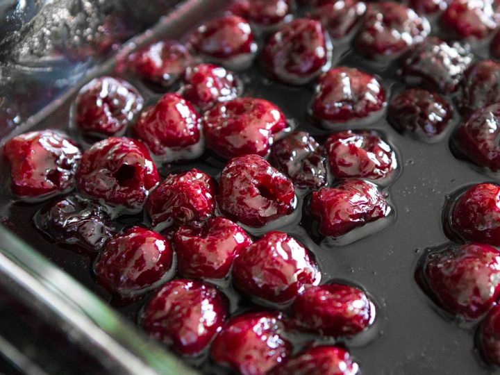 Roasted cherries in a baking dish.