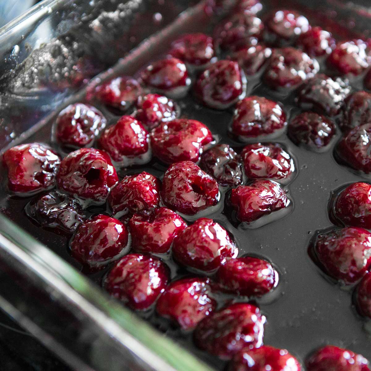 Roasted cherries in a baking dish.