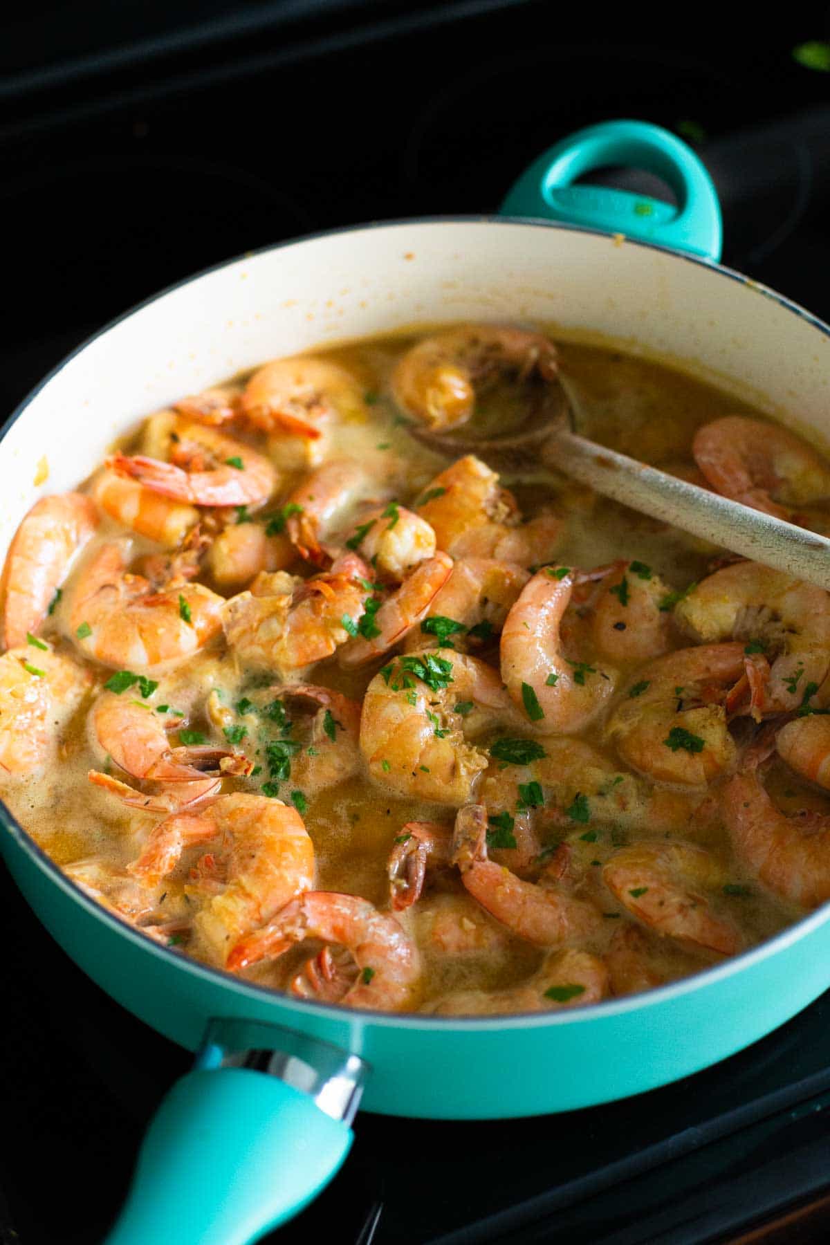 The shrimp have finished cooking in the skillet and are nice and pink.