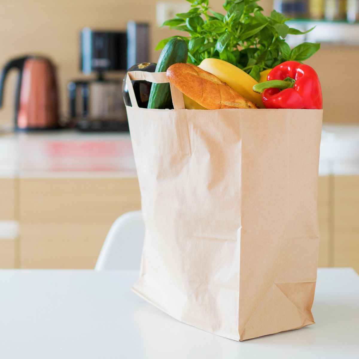A bag of groceries sits on the kitchen counter.