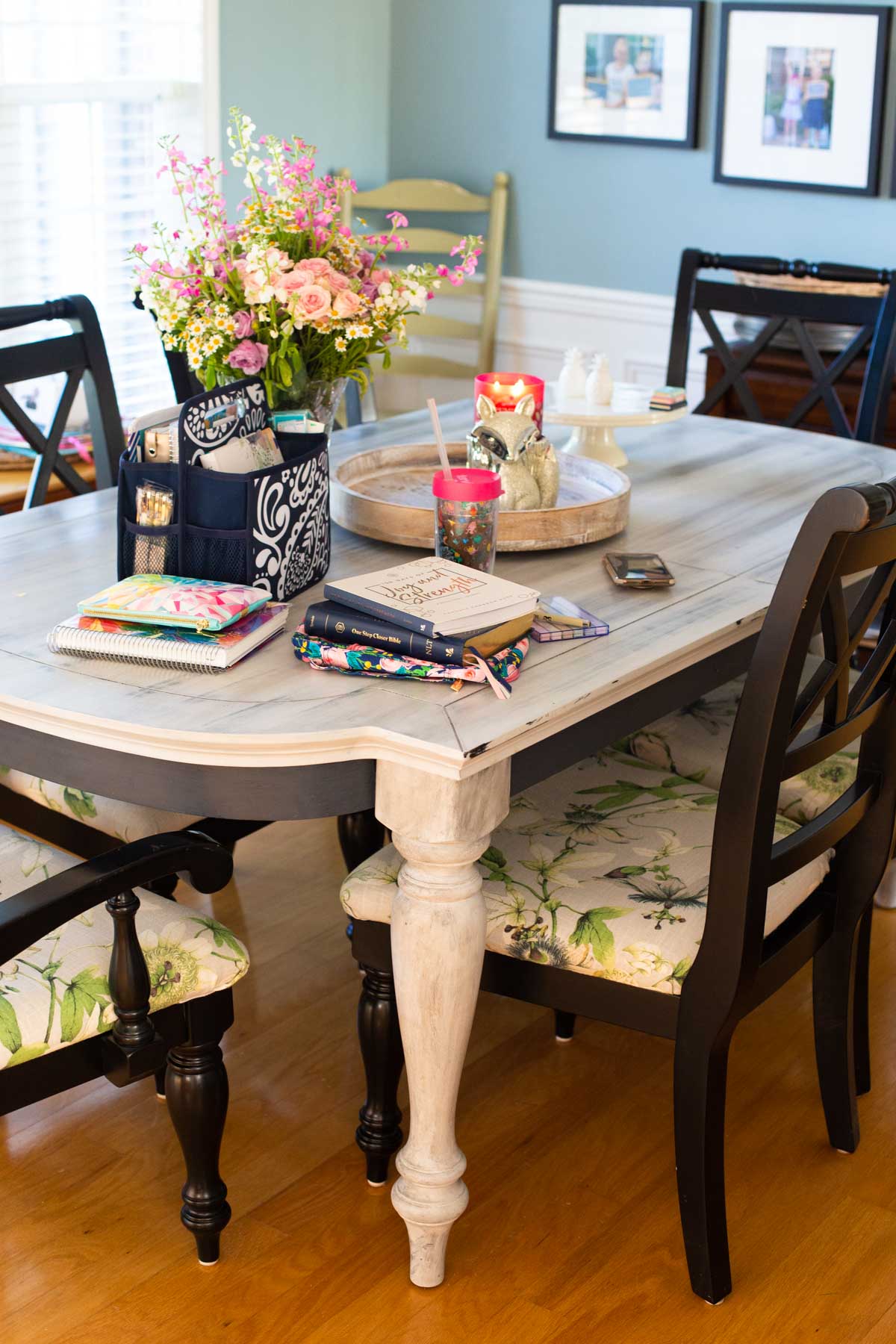 The dining table is set for a mom's morning time with a morning basket, coffee, and fresh flowers.