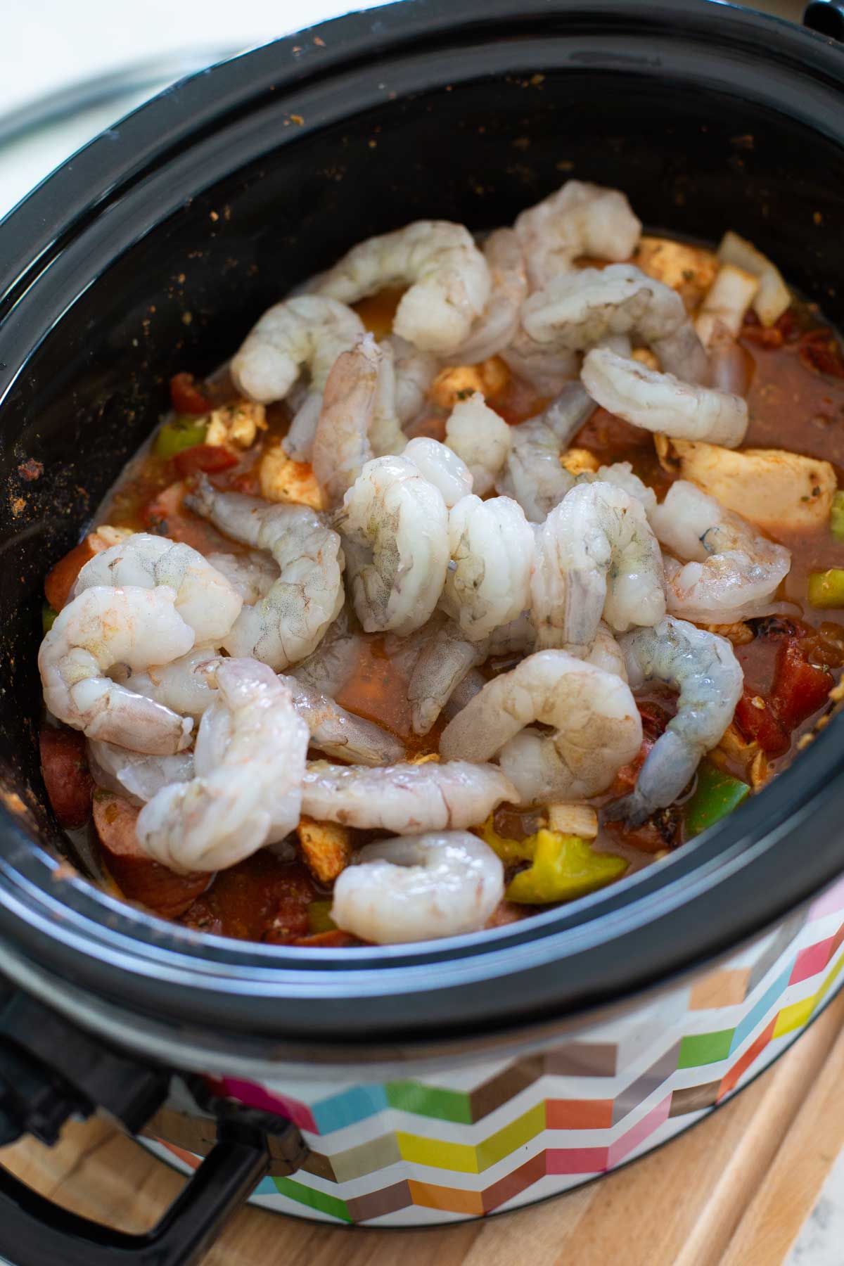 The shrimp are added to the slowcooker last since they cook quickly.