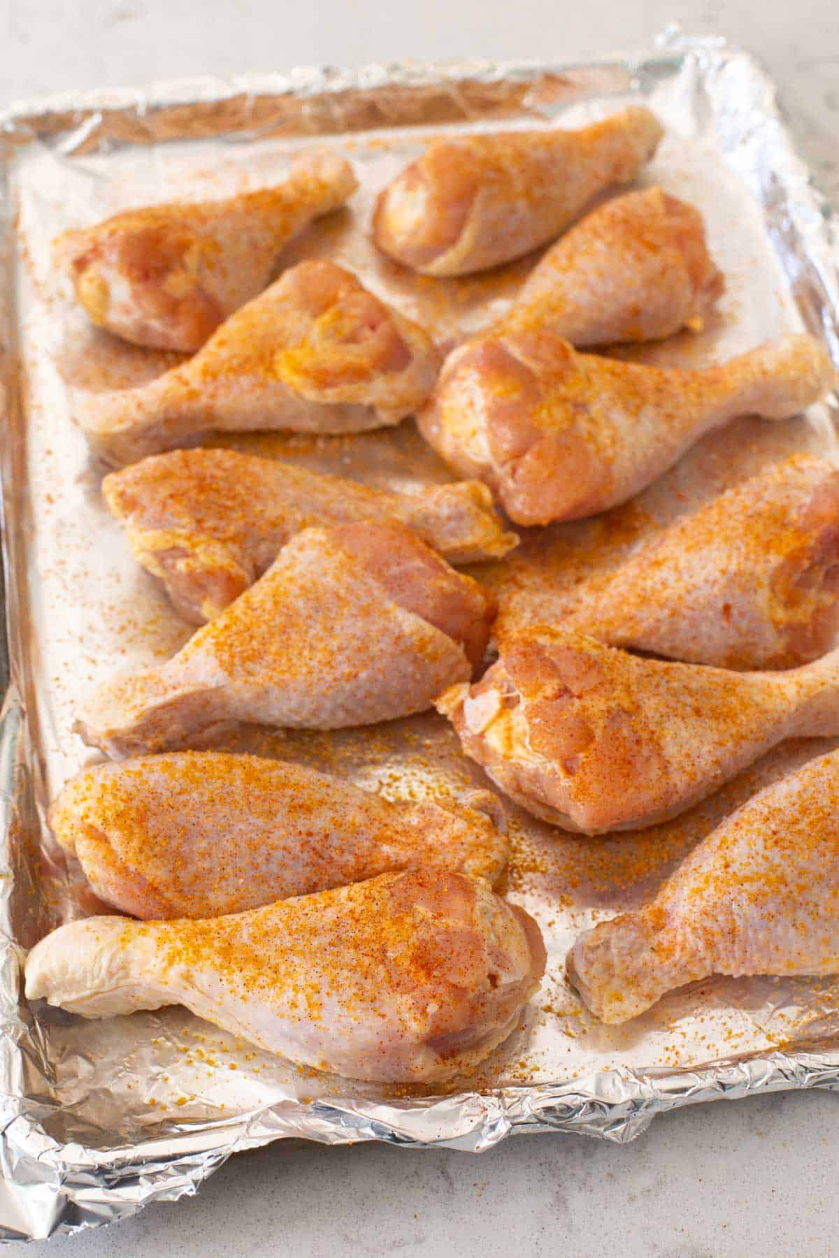 The seasoned chicken legs are ready to go in the oven.