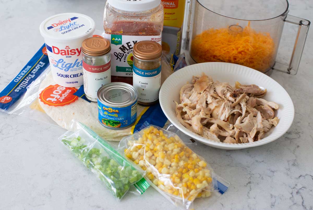 The ingredients to make homemade chicken chimichangas are on the counter.