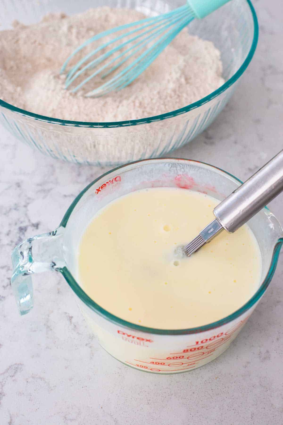 The milk and eggs have been whisked together and ready to be added to the bowl.