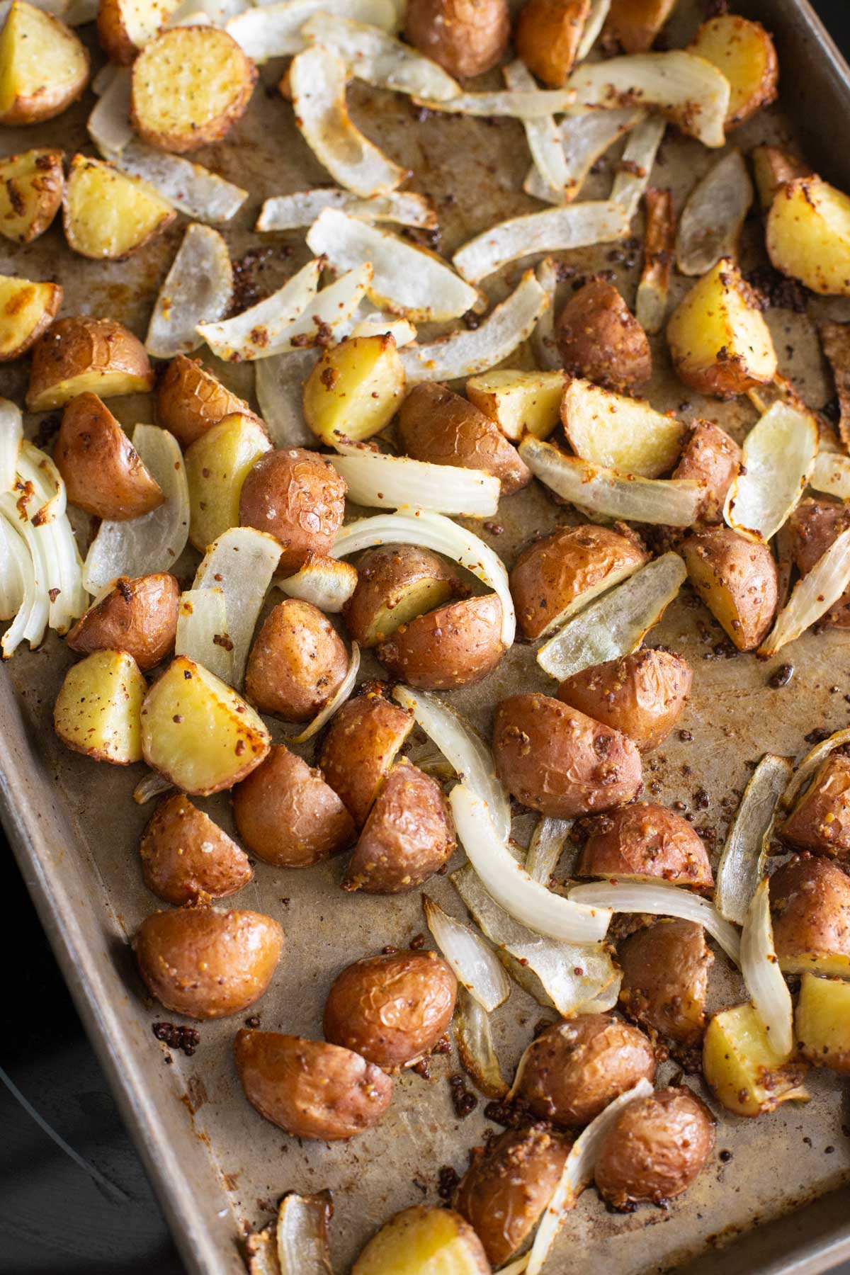 The roasted potatoes on the baking sheet out of the oven.