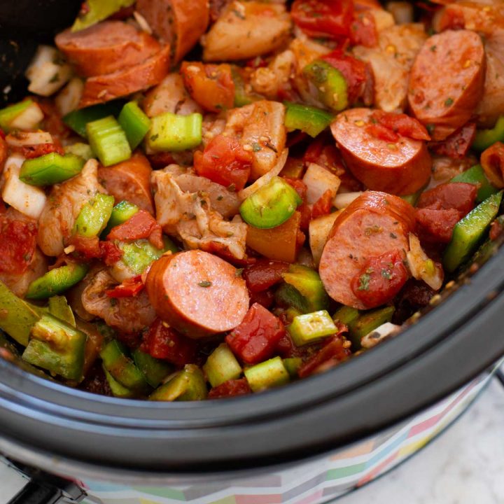 The cooked sausage and peppers and celery in a slow cooker.