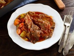 A white dinner bowl has Tori Avey's holiday brisket ready to eat.