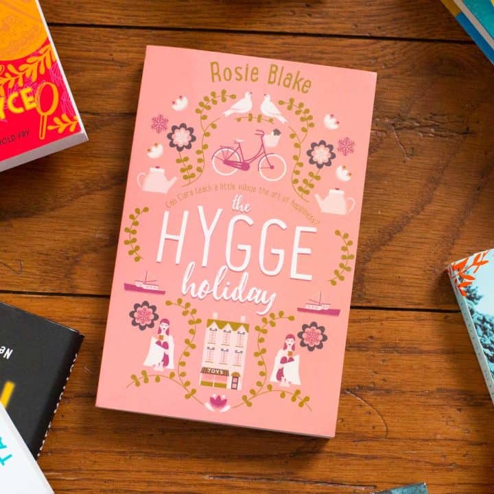A copy of The Hygge Holiday sits on a table.