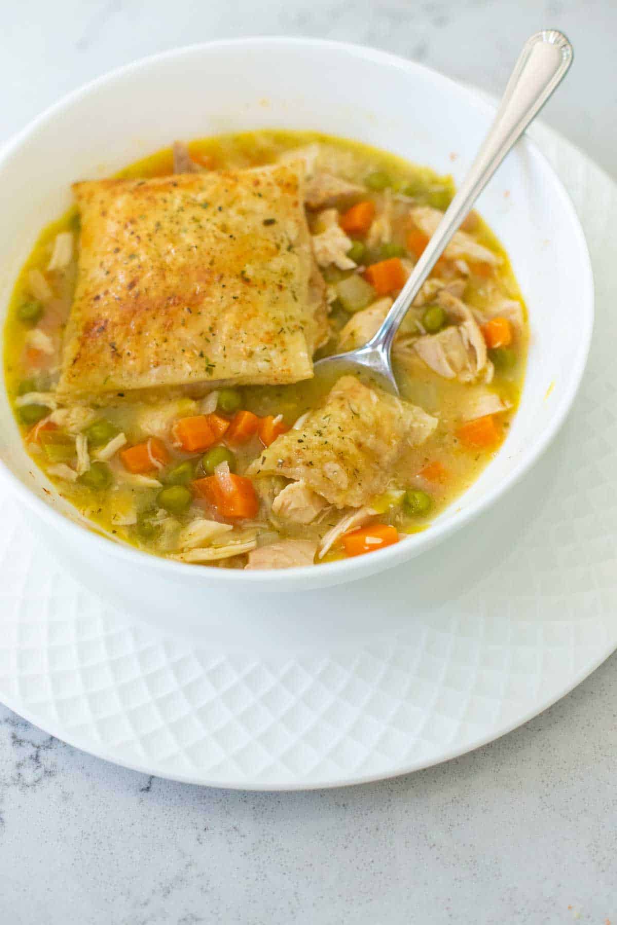 The squares of puff pastry have been added to the soup.