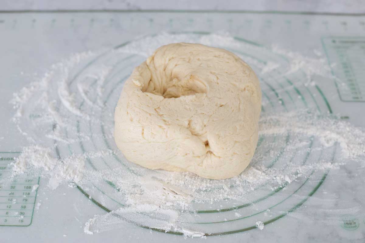 The cinnamon bread dough is on the baking mat.