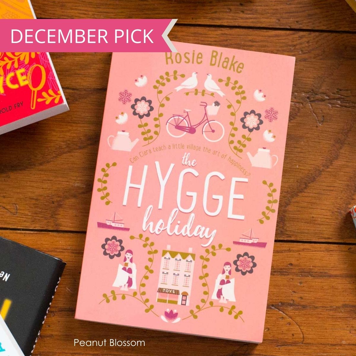 A copy of The Hygge Holiday sits on a table.