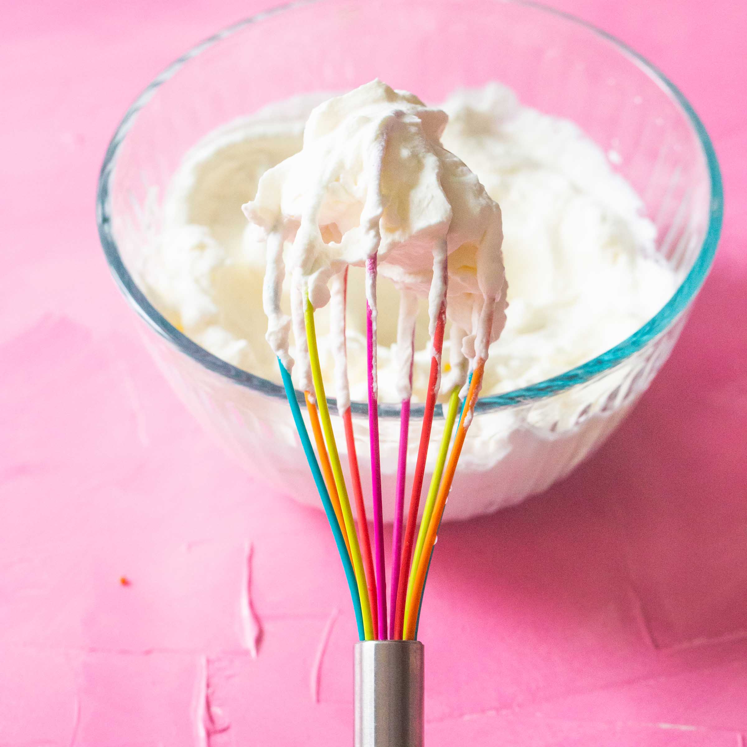 A whisk is whipping up cream.