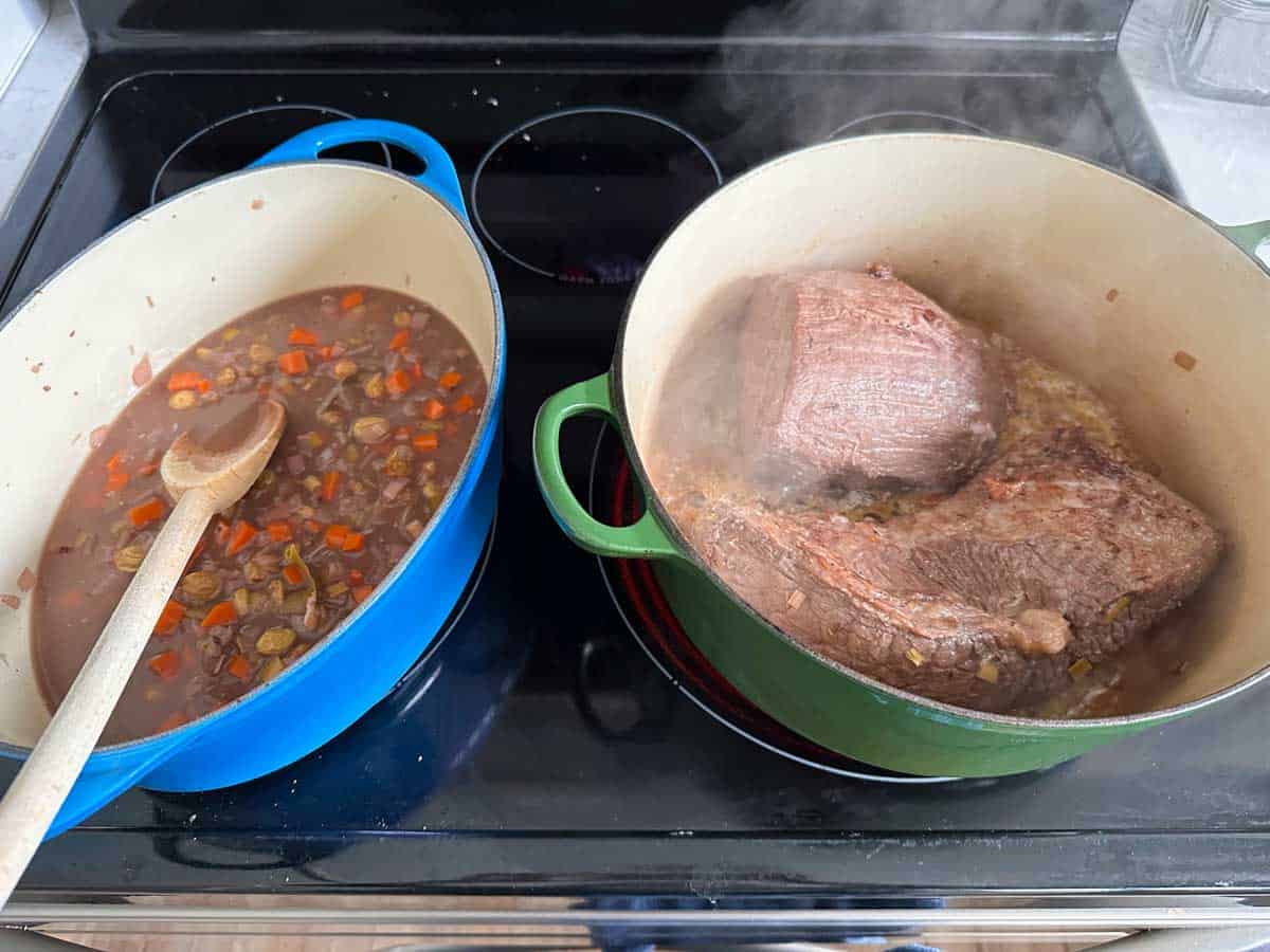 The beef has been drained from marinade, dried, and is now browning in a large dutch oven.