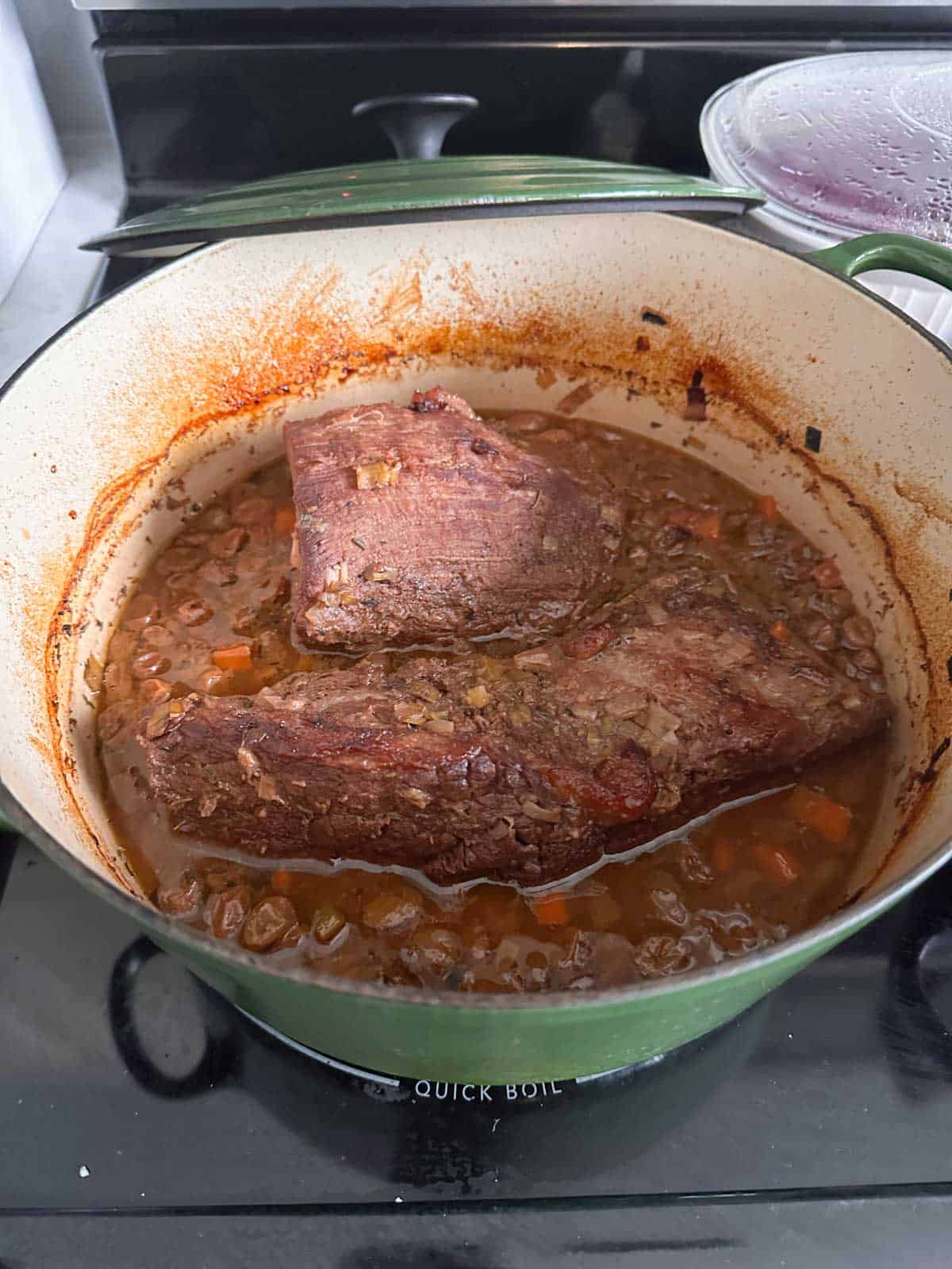 The sauerbraten is finished cooking, the vegetables are soft, and the gravy is ready.